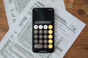 https://www.pexels.com/photo/tax-forms-with-calculator-on-wooden-surface-6927334/